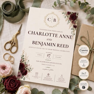 May include: A wedding invitation card featuring dark red roses and eucalyptus foliage, with the names Charlotte Anne and Benjamin Reed printed in dark red text. The card includes a gold monogram, date, location, and RSVP details on a cream background.