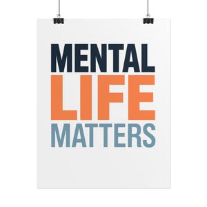 May include: A white rectangular poster featuring the text MENTAL LIFE MATTERS in bold, sans-serif capital letters. The word MENTAL is dark blue, LIFE is orange, and MATTERS is light blue. The poster is suspended by two black metal clips.