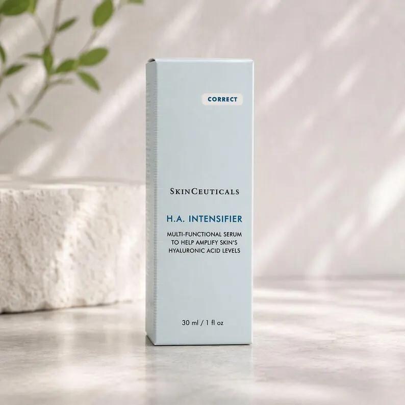 May include: A light blue rectangular skincare product box labeled SkinCeuticals H.A. Intensifier multi-functional serum. The front of the box features the text Correct, the brand name, product name, description, and a volume of 30 ml / 1 fl oz.
