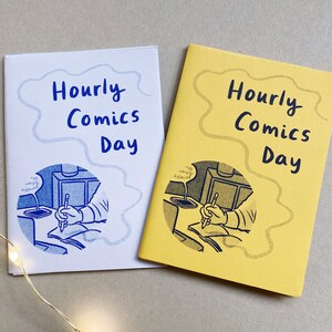 Two mini zines called Hourly Comics Day, one printed on lilac paper and one on yellow paper.