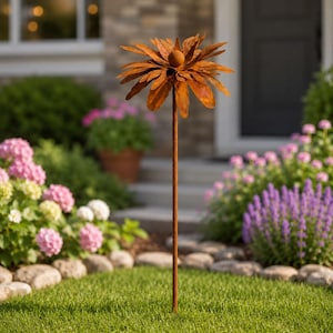 May include: A rust-colored metal garden stake featuring a large, stylized flower head with layered, pointed petals and a central spherical accent. The sculpture is mounted on a thin, straight metal rod, creating a decorative outdoor accent.