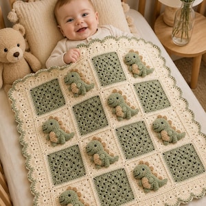 May include: A square crochet baby blanket featuring a grid of alternating cream-colored floral motifs and sage green squares, each adorned with a small, three-dimensional stuffed dinosaur appliqué. The blanket has a scalloped cream-colored border.
