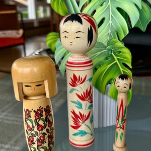 Lovely - Three delightful Kokeshi dolls. Well made with beautiful colors and designs. Artist signed. Made in Japan.  Lovely collectibles.