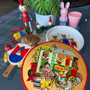 A fun bundle of vintage and antique decorative toys. 1040s to the 1980s. Rattles, bear bowl, puzzle, toothbrush holder/rattle and more.