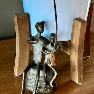 Very sweet. A bronze sculpture of a father and son fishing. Well made bronze sculpture perhaps from the 1960s. Lovely nostalgic decor.