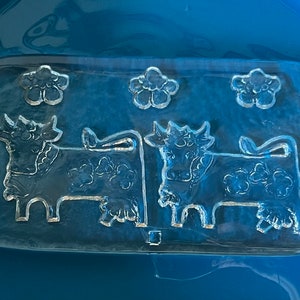 Delighful!  Glasi Hergiswil - Olma butter/cheese/appetizer glass platter. Sweet Olma Swiss cows and flowers with embossed reverse design.