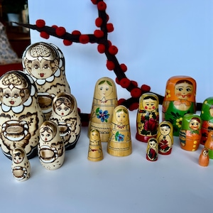 Four lovely vintage Matryoshka/nesting dolls. Made in Russia. Beautiful colors and shapes. Traditional and ornate. Lovely collectible dolls.