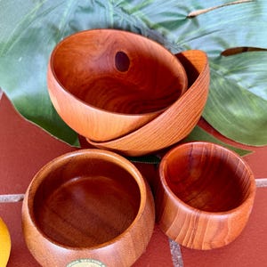 Four lovely small vintage wood bowls - 1966 AWWA bowl with CA label, Two teak bowls and artist signed grain bowl.