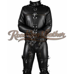 May include: A black leather restraint suit featuring a high collar, long sleeves, and integrated metal D-rings. The jacket includes a central vertical strap with buckles, while the trousers feature multiple leg straps with padlocks and zippers.