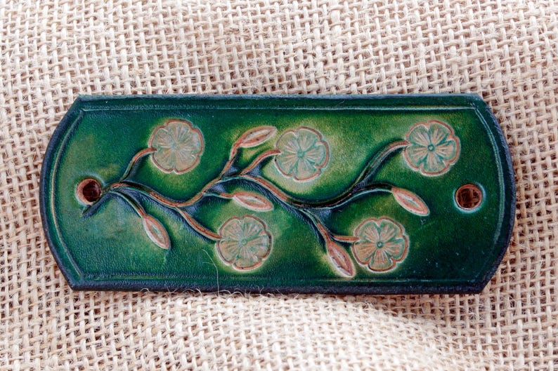 Green leather hair barrette.