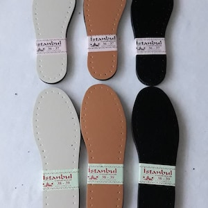 May include: Six leather shoe insoles in three colors: white, brown, and black. Each insole has a label with the text "Istanbul" and size numbers 36-37 or 38-39.