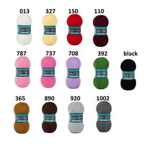 May include: A collection of colorful yarn skeins, each labeled with a number. Colors include white, yellow, red, burgundy, pink, purple, green, brown, gray, and black. The brand name "KARTOPU SUPER PERLE" is printed on each label.