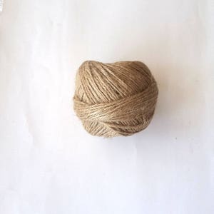 May include: A ball of natural brown twine, perfect for crafting and DIY projects.