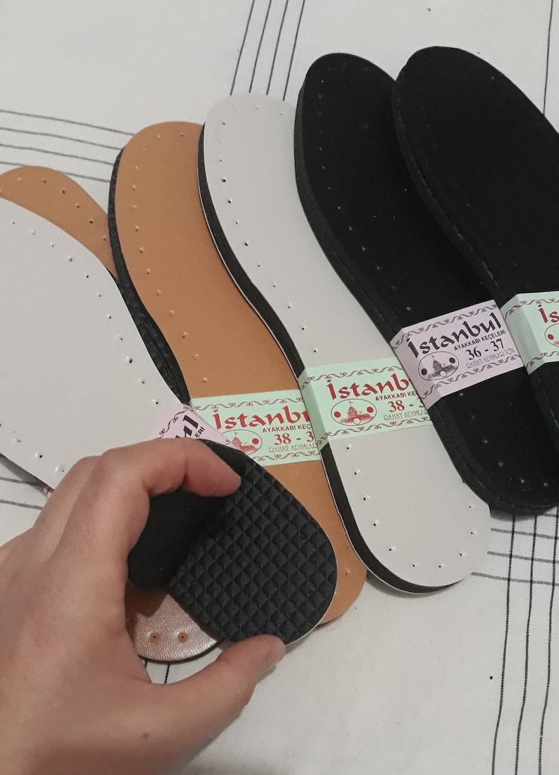 May include: Four pairs of shoe insoles, two brown, one white, and one black. The insoles have a label that reads "Istanbul Ayakkabı Ke&ccedil;eleri" with sizes 36-37, 38-39, and 38-39.