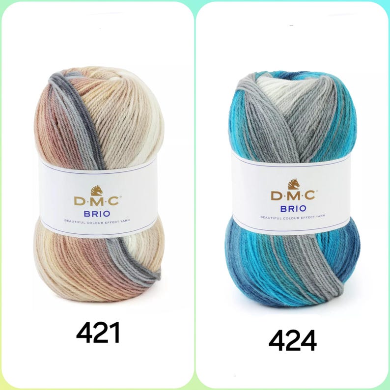 May include: Two skeins of DMC Brio yarn, one in a beige and brown colorway and the other in a blue and gray colorway. The yarn is labeled with the DMC Brio logo and the color numbers 421 and 424.