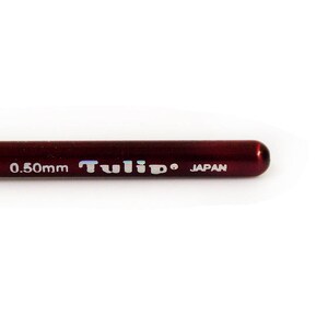 May include: Close-up of a red Tulip brand crochet hook with the text "No. 22 0.50mm JAPAN" printed on the side.