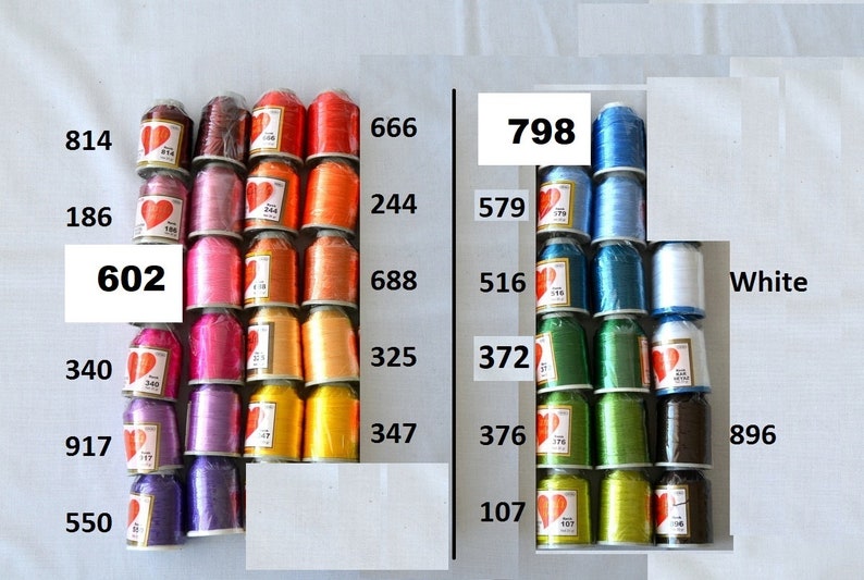 May include: A collection of spools of thread in various colors, including red, orange, yellow, green, blue, and purple. The spools are arranged in rows and labeled with numbers, such as 602, 340, 917, 550, 666, 244, 688, 325, 347, 798, 579, 516, 372, 376, 107, and 896. The spools are all the same size and shape, and they are arranged in a neat and orderly fashion.