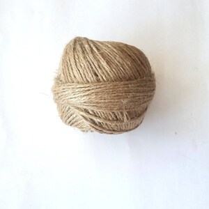 May include: A ball of natural brown twine or string.