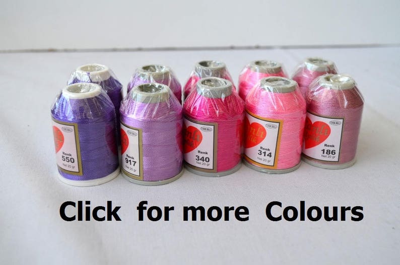 May include: Assortment of 10 spools of embroidery thread in various shades of pink and purple. Each spool is labeled with a number and the word "Rank".