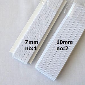 May include: Two rolls of white elastic, one 7mm wide labeled "no:1" and the other 10mm wide labeled "no:2".