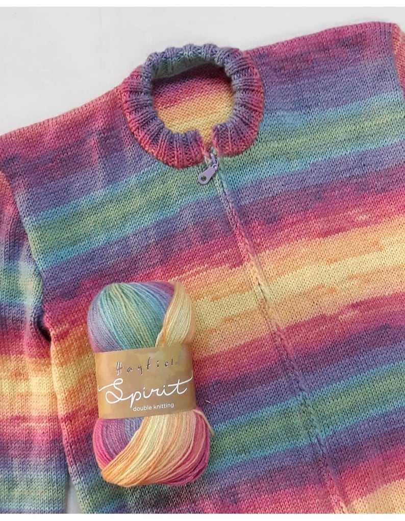 May include: A rainbow striped knitted cardigan with a zipper closure. The cardigan is made with Hayfield Spirit double knitting yarn.
