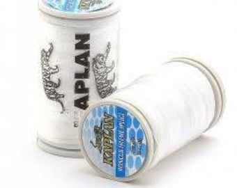 May include: Two spools of white thread with a white and blue label that says "KAPLAN" and features a stylized image of a cat. The label also says "WONDER LINE THREAD" and "100% POLYESTER".
