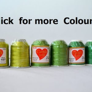 May include: Six spools of green and yellow thread with the brand name "Canli Iplik" and the words "Polyester Bantel Ipligi" printed on the labels. The spools are labeled with the numbers 107, 376, and 372.