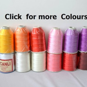 May include: A collection of 10 spools of thread in various colors, including yellow, orange, red, pink, purple, and brown. The spools are labeled "CANLI" and "PATENTED DANTELLI SPA.G"