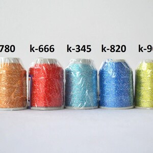 May include: Five spools of metallic thread in different colors: gold, red, turquoise, blue, and green. The spools are labeled with the following codes: k-780, k-666, k-345, k-820, and k-908.