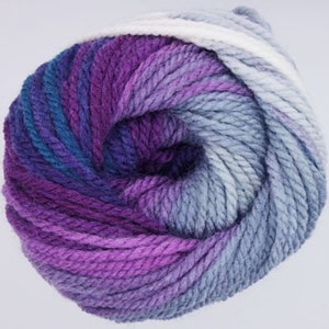May include: A skein of yarn in a purple, blue, and white ombre colorway. The yarn is soft and fluffy, and it would be perfect for knitting or crocheting a cozy blanket or scarf.