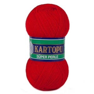 May include: A vibrant red ball of yarn with a label that reads "KARTOPU SUPER PERLE" in white and gold lettering. The label is green and blue. This yarn is likely used for knitting or crocheting projects.