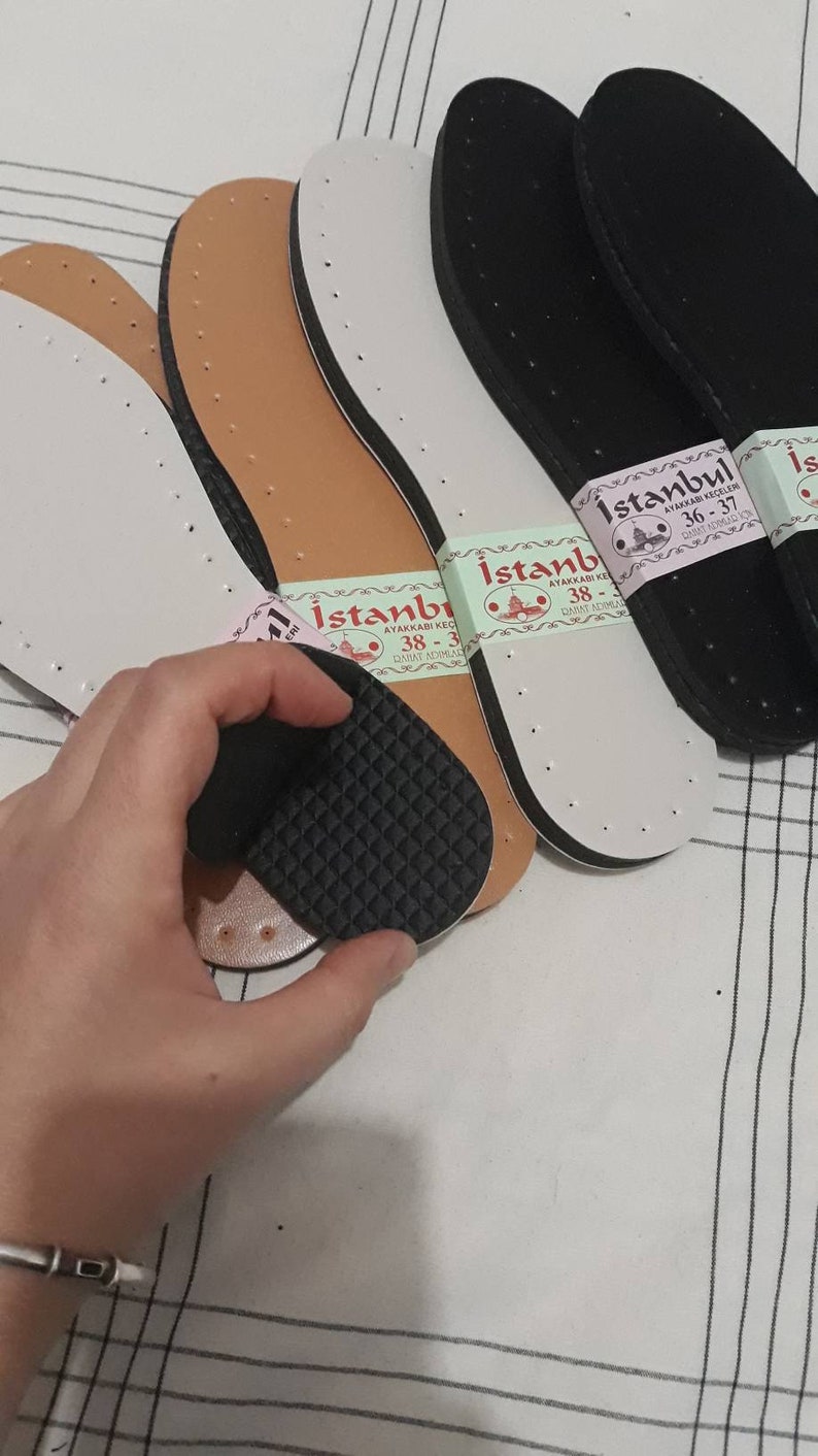 May include: Four pairs of shoe insoles, two brown, one white, and one black. The insoles are labeled "Istanbul Ayakkabı Keczileri 36-37" and "Istanbul Ayakkabı Keczileri 38-39".