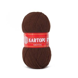 May include: A ball of brown yarn with a red label that says "KARTOPU KRISTAL".