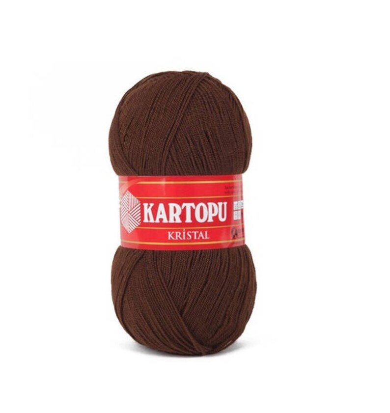 May include: A ball of brown yarn with a red label that says "KARTOPU KRISTAL".