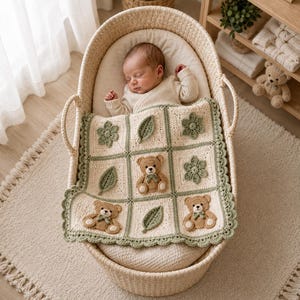 May include: A cream-colored crochet baby blanket featuring a grid pattern with sage green borders. The blanket displays three-dimensional appliqués of brown teddy bears, sage green leaves, and sage green flowers, finished with a scalloped edge.