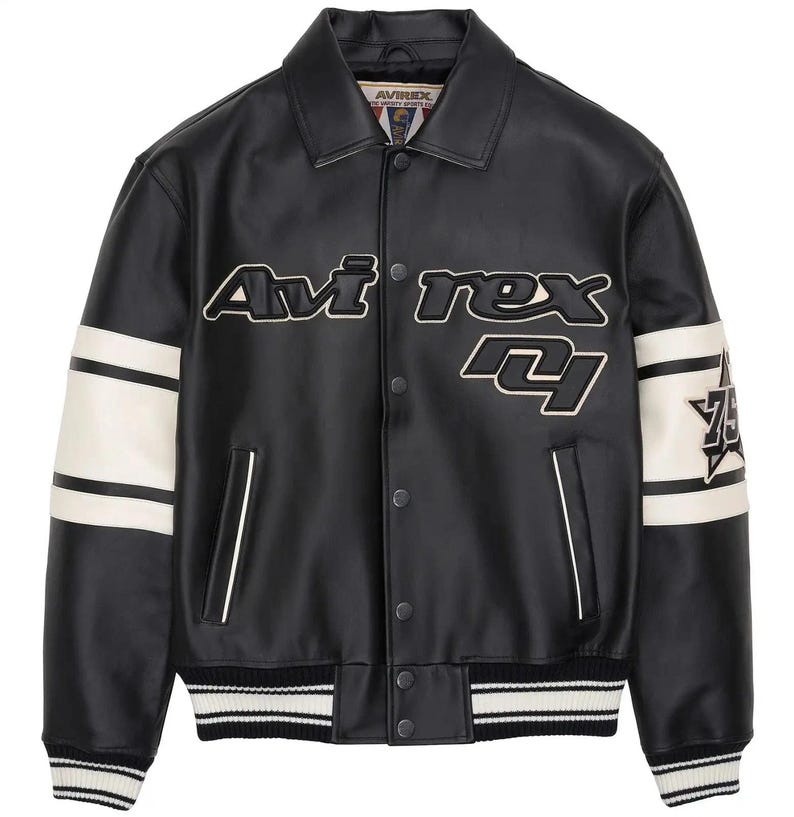 May include: A black faux leather varsity jacket featuring a pointed collar, snap button closure, and two front pockets. The chest displays the text Avirex in white and black. Each sleeve has two white stripes and a star patch with the number 75.