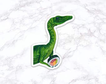 May include: A green dinosaur-like creature with a long neck holding a sushi roll in its hand. The sushi roll is wrapped in seaweed and has pink, orange, and green filling.