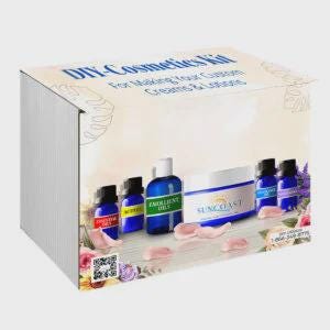 May include: A DIY Cosmetics Kit box for making custom creams and lotions. The packaging features floral graphics and displays several small blue bottles labeled Essential Oils, Butters, and Emollient Oils, alongside a Suncoast cream jar.