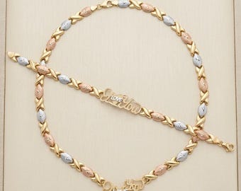 May include: A tri-color gold necklace and bracelet set featuring an X-shaped link pattern in yellow, rose, and white gold. Both pieces include a central decorative plaque with the script text "LOVE YOU" in a combination of yellow and white gold.