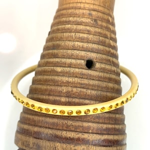Celluloid Bangle Bracelet with 1 Row of Topaz Colored Rhinestones