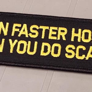 May include: A rectangular black embroidered patch with a stitched border. The patch features the yellow text "I RUN FASTER HORNY THAN YOU DO SCARED" in a bold, sans-serif font, centered across the fabric surface in two distinct lines.