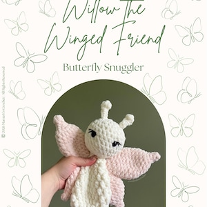 May include: A crochet butterfly snuggler with a white head and body and light pink wings. The text reads Willow The Winged Friend Butterfly Snuggler @mamakscrochet. The background features green line-art butterfly illustrations on a white field.