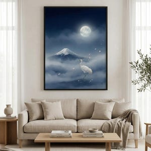May include: A rectangular wall art print in a black frame featuring a white crane standing amidst clouds with a snow-capped mountain peak in the background under a full moon in a dark blue night sky with scattered pink flower petals.
