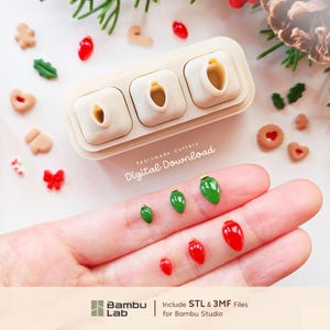 May include: A beige plastic triple-cavity mold for creating small Christmas light bulb shapes, accompanied by six miniature green and red light bulb decorations. The text Pearnmade Cutters Digital Download and Bambu Lab Include STL & 3MF Files for Bambu Studio are visible.