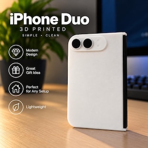 May include: A white 3D printed iPhone Duo stand with a black spine and two circular black lens cutouts on the top corner. The text iPhone Duo 3D PRINTED SIMPLE CLEAN is visible along with icons for modern design, gift, home, and a leaf.