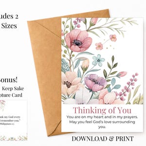 May include: A greeting card featuring watercolor flowers in shades of pink, purple, and green. The text reads Thinking of You, You are on my heart and in my prayers. May you feel God's love surrounding you. Includes a 3x3 inch scripture card.