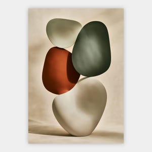 Op de afbeelding: Een verticale opstelling van vier gladde, afgeronde, kiezelachtige vormen gestapeld in een gebalanceerde compositie. De vormen omvatten een lichtgrijs bovenstuk, een donker bosgroene vorm, een terracotta oranje element en een grote gebroken witte basis.