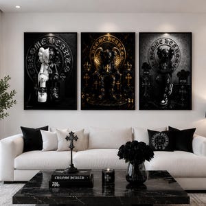 May include: A set of three rectangular wall art prints featuring stylized figures with X-shaped eyes and the text CHROME HEARTS in circular motifs. The artwork displays a dark color palette with black, white, and gold accents, depicting figures in throne-like settings with cross symbols and ornate details.