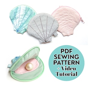 May include: A collection of seashell-shaped pouches in various colors, including light blue, gray, and pink. One pouch is open, revealing a pearl. The image also includes text that reads "PDF SEWING PATTERN + Video Tutorial."