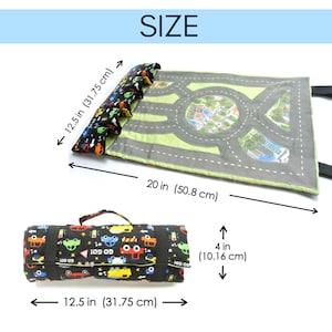 May include: A black and green playmat with a city road design. The playmat rolls up and has a handle. The playmat is 20 inches by 12.5 inches.